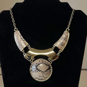 Mark for Avon gold tone necklace with faux snakeskin inlays.